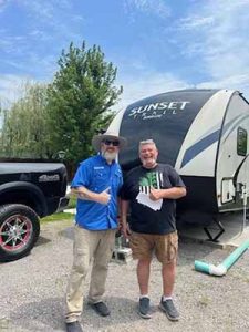 Chris Dakin of Kleen Tank on the Road No. 7 with a satisfied customer